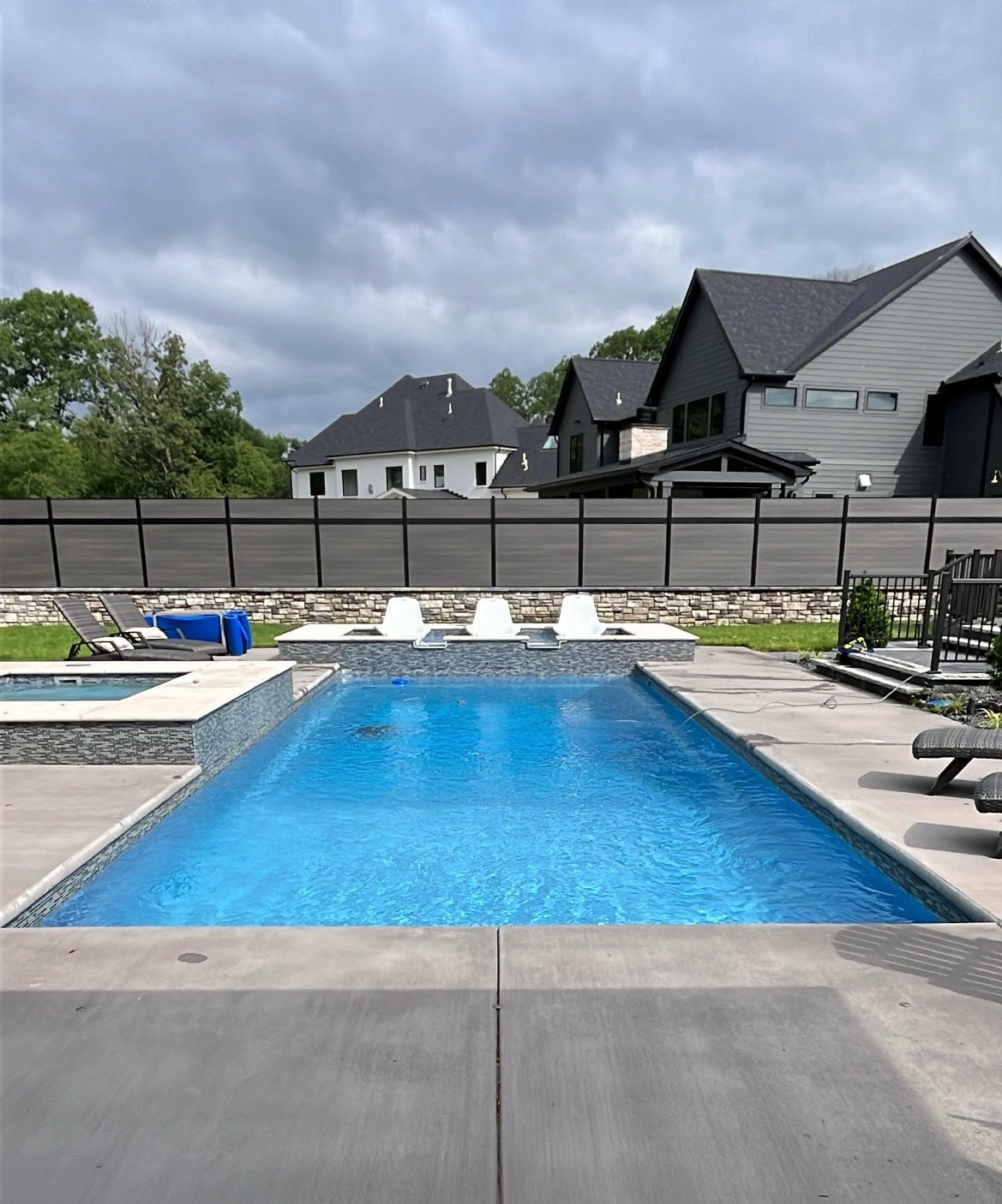 Residential pool with attached spa and tanning ledge