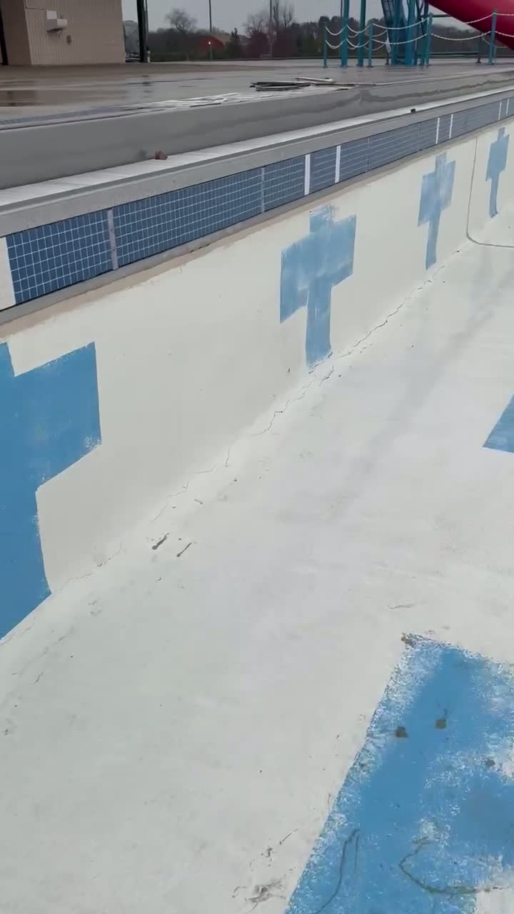 Video of a drained commercial pool basin prepared for rehabilitation